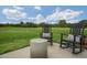 Backyard featuring a concrete patio and two black rocking chairs with pillows overlooking a grass yard at 113 Reagan Crest Dr, Clayton, NC 27520