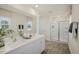 Bright bathroom with double vanity, large mirror, and glass-enclosed shower at 113 Reagan Crest Dr, Clayton, NC 27520