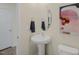 A simple and clean powder room with a pedestal sink, oval mirror, and a fresh, modern aesthetic at 113 Reagan Crest Dr, Clayton, NC 27520