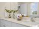 Bathroom with double sinks, white countertops and cabinets, large mirrors, and a window at 113 Reagan Crest Dr, Clayton, NC 27520