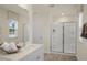 Bathroom featuring a glass-door shower, neutral walls, a window and a sink with white countertops at 113 Reagan Crest Dr, Clayton, NC 27520