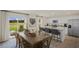Open dining area with wood table and chairs, flowing into a kitchen with bar seating and stainless appliances at 113 Reagan Crest Dr, Clayton, NC 27520