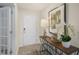 Entryway featuring a hardwood floor, white door and a decorative table with orchids at 113 Reagan Crest Dr, Clayton, NC 27520
