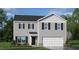 Charming two-story home featuring gray siding, black shutters, and a two-car garage at 113 Reagan Crest Dr, Clayton, NC 27520
