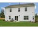 Rear exterior of a two-story home with a large backyard, patio and rocking chairs at 113 Reagan Crest Dr, Clayton, NC 27520