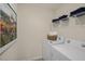 Convenient laundry room featuring a washer, dryer, and ample storage shelves at 113 Reagan Crest Dr, Clayton, NC 27520