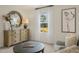 Bright living room featuring neutral walls, stylish decor and a large round mirror above the dresser at 113 Reagan Crest Dr, Clayton, NC 27520