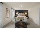 Elegant main bedroom with wallpaper accent wall, cozy seating, and plush carpet at 113 Reagan Crest Dr, Clayton, NC 27520