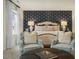 Inviting main bedroom with bed, accent wall, two chairs, and stylish decor at 113 Reagan Crest Dr, Clayton, NC 27520