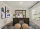 This home office features a dark wood desk and stylish decor, with a window providing natural light at 113 Reagan Crest Dr, Clayton, NC 27520