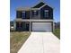 Charming two-story home featuring a two-car garage and a well-manicured front lawn on a sunny day at 120 Vili Dr, Broadway, NC 27505