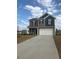 Attractive gray two-story home with a two-car garage and a concrete driveway on a partially cloudy day at 120 Vili Dr, Broadway, NC 27505