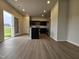 Modern kitchen with an island, dark cabinetry, stainless steel appliances, and wood-look flooring at 120 Vili Dr, Broadway, NC 27505