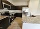 Beautiful kitchen with dark cabinetry, granite countertops, and stainless steel appliances for a modern look at 120 Vili Dr, Broadway, NC 27505