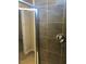 Modern tiled shower and a glass door, with a view to a walk-in closet at 120 Vili Dr, Broadway, NC 27505