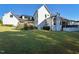 Spacious backyard view highlighting the lush lawn and architectural details of the white home exterior at 1425 Sky Vista Way, Raleigh, NC 27613
