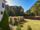 Expansive backyard view showcasing the lush lawn, mature trees, and manicured landscaping, perfect for outdoor activities at 1425 Sky Vista Way, Raleigh, NC 27613