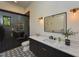 Modern bathroom featuring a glass shower with stylish tile, black vanity, marble countertop, and contemporary fixtures at 1425 Sky Vista Way, Raleigh, NC 27613