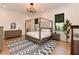 Inviting bedroom with a four-poster bed, neutral tones, and a decorative rug at 1425 Sky Vista Way, Raleigh, NC 27613