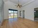 Light-filled bedroom with hardwood floors, large windows offering neighborhood views, and ensuite bathroom at 1425 Sky Vista Way, Raleigh, NC 27613