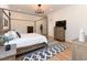 Warm bedroom with a four-poster bed, wood floors, and a geometric-patterned rug at 1425 Sky Vista Way, Raleigh, NC 27613