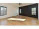 Bedroom with natural light from large windows, custom millwork, and hardwood floors at 1425 Sky Vista Way, Raleigh, NC 27613