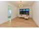 Versatile bonus room with hardwood floors, ample natural light, a modern couch, and ensuite bath at 1425 Sky Vista Way, Raleigh, NC 27613