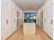 Long walk-in closet featuring custom cabinetry, granite counters, and ample storage space at 1425 Sky Vista Way, Raleigh, NC 27613