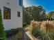 Home exterior showcasing well-maintained landscaping, mature trees, and a stone pathway leading to the backyard at 1425 Sky Vista Way, Raleigh, NC 27613