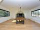 Game room featuring hardwood floors, a pool table, and generous natural light from the large windows at 1425 Sky Vista Way, Raleigh, NC 27613