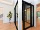 Hallway with plant, wine storage room, stairway and view of the living room at 1425 Sky Vista Way, Raleigh, NC 27613