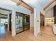 Bright hallway featuring hardwood floors, and glass enclosed room at 1425 Sky Vista Way, Raleigh, NC 27613