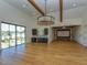 Spacious living room with hardwood floors, exposed beams, large windows and custom built-ins for entertaining at 1425 Sky Vista Way, Raleigh, NC 27613