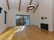 Living room showcasing exposed beams, and a cozy fireplace with modern lighting at 1425 Sky Vista Way, Raleigh, NC 27613