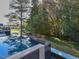 Backyard featuring a pool reflecting the beautiful trees, creating a serene and natural outdoor oasis at 1425 Sky Vista Way, Raleigh, NC 27613