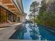 A modern pool with lounge chairs and an outdoor living space in a well-maintained backyard at 1425 Sky Vista Way, Raleigh, NC 27613