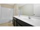 Bright bathroom featuring a double sink vanity, a large mirror, and a shower-tub combination at 1732 Great Bend Dr, Durham, NC 27704
