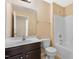 Bright bathroom featuring a sink vanity, toilet, and a shower-tub combination at 1732 Great Bend Dr, Durham, NC 27704