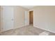 This bedroom has carpet flooring, neutral paint, and two doors at 1732 Great Bend Dr, Durham, NC 27704