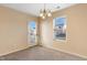 Well-lit dining area featuring neutral carpeting and a door to the backyard at 1732 Great Bend Dr, Durham, NC 27704