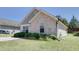 A single-story exterior shows stone and vinyl siding, a manicured lawn and minimal plantings at 1732 Great Bend Dr, Durham, NC 27704