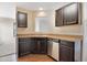 Kitchen featuring modern appliances, wooden floors, and dark cabinets at 1732 Great Bend Dr, Durham, NC 27704