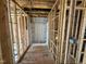 Unfinished bathroom with wood framing and a pre-fabricated shower stall at 2155 Pink Peony Cir # 235, Durham, NC 27703