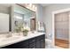Stylish bathroom with double vanity, large mirror, and a walk-in shower with tiled walls, plus a storage area at 2155 Pink Peony Cir # 235, Durham, NC 27703