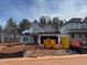 New home construction with visible frame; construction equipment and building supplies present at 2155 Pink Peony Cir # 235, Durham, NC 27703