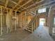 Interior framing with visible studs, stairs, and open spaces showcasing the structure of the new home at 2155 Pink Peony Cir # 235, Durham, NC 27703