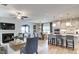 Open concept living space with a fireplace, kitchen, dining area, and hardwood floors, perfect for entertaining at 2155 Pink Peony Cir # 235, Durham, NC 27703