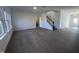 Spacious living room with hardwood floors and stairway to upper level at 5168 Church Rd # 22, New Hill, NC 27562