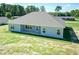 Aerial view of backyard showcasing the home's covered patio and well-maintained lawn at 587 Glenkirk Pl, Garner, NC 27529
