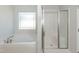 Bathroom with a soaking tub and separate glass shower at 587 Glenkirk Pl, Garner, NC 27529